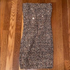 A gold strapless sequin dress